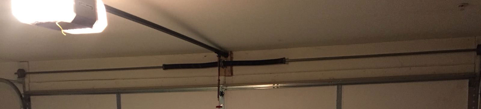 Installed LiftMaster electric garage door opener with safety sensors in Chaska home garage